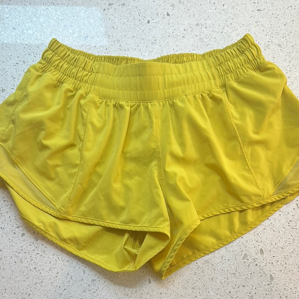 Women's Lululemon Athletic Shorts in bright yellow. Mesh side panels in sz 6R.